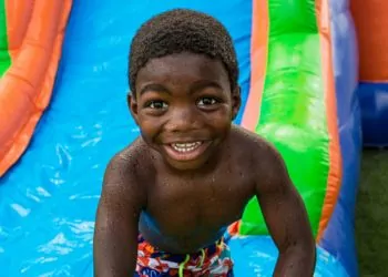 Boy playing on water slide